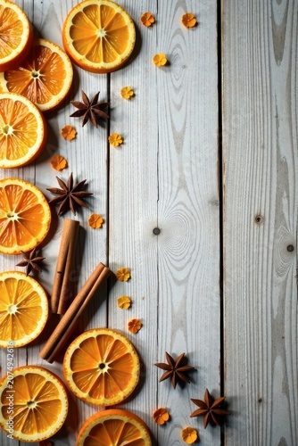 Aromatic Citrus Slices, Cinnamon Sticks, and Star Anise Arranged on a Rustic Wooden Surface