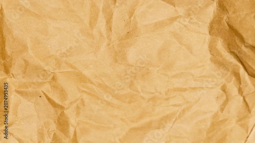 Crumpled Brown Kraft Paper Texture Background. Detailed Macro Shot of Wrinkled Packing Paper with Deep Creases and Folds