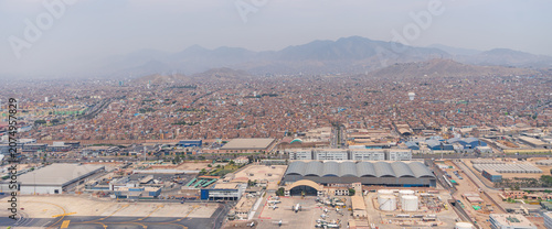 Aerial view of Lima city and Jorge Chavez International Airport with Andes Mountains in Peru