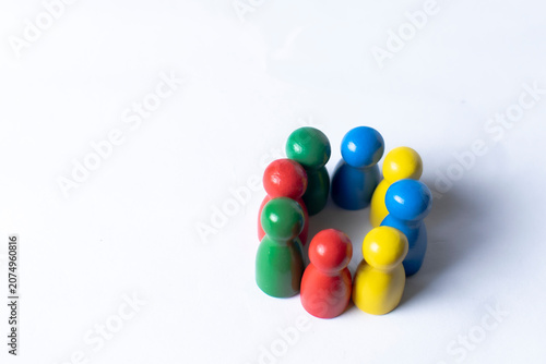 Diverse group of colorful wooden figures representing inclusion equality and community