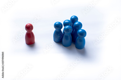 Individual standing apart from a group representing social exclusion and discrimination