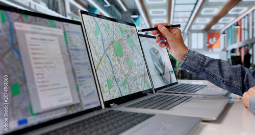 Fotografie Woman Urban Planner Analyzes City Land Maps On Laptop