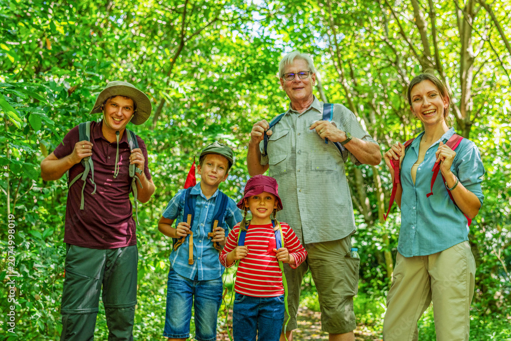 Fototapeta premium Family hiking in lush forest