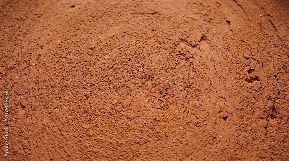 Fototapeta premium Closeup of rough red clay surface.
