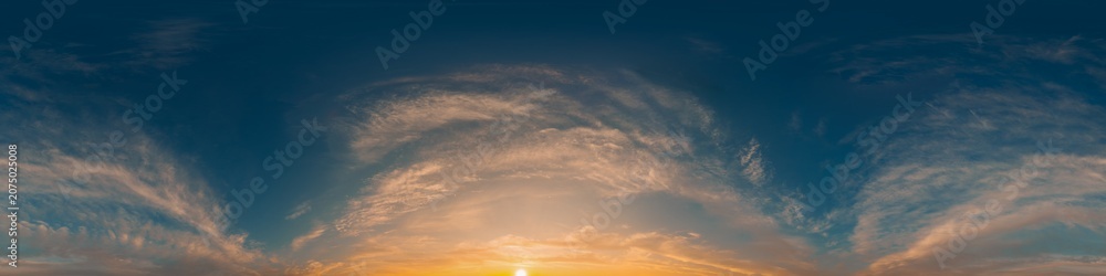 Obraz premium Panorama sunset sky with golden light and wispy clouds in a clear 360 degree equirectangular view with copy space