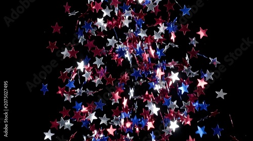 Patriotic red white and blue star confetti falling against a dark background for 4th july independence day celebration party background