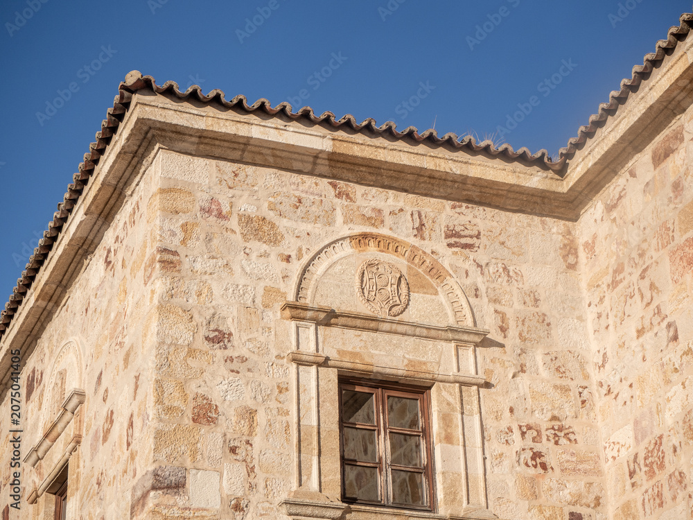 Naklejka premium Old building facade with stone wall and window
