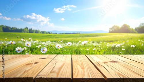 Wooden table overlooking green field landscape.