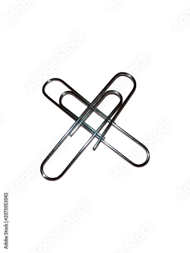 Two metal paper clips crossed in an x shape