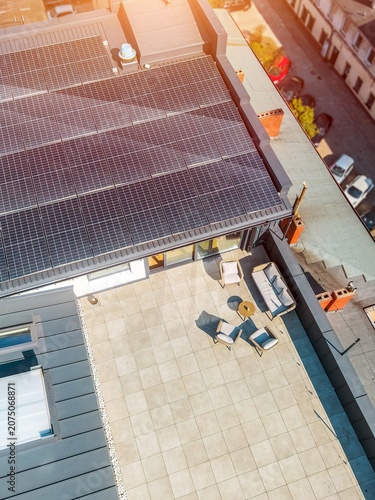 Urban home rooftop terrace with solar energy panels