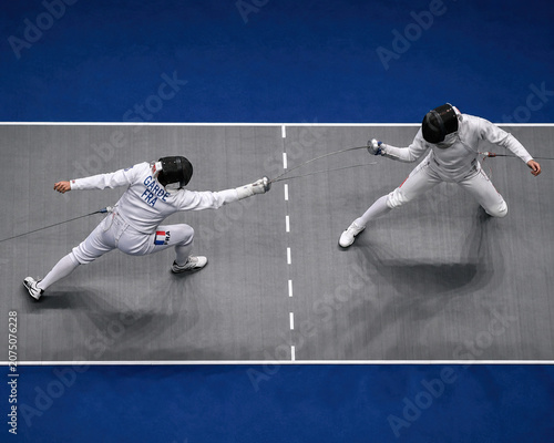 Two Fencers Competing in a Competitive Fencing Match