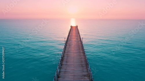 Sunset tranquil ocean with wooden pier