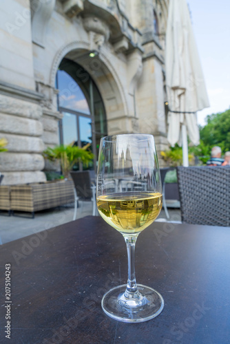 Glass of White Wine on an Elegant Outdoor Cafe Terrace in Summer