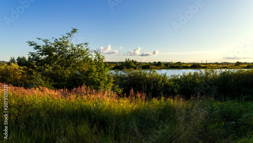 Obraz na płótnie Amazing view at scenic landscape on a beautiful lake and colorful sunset with re