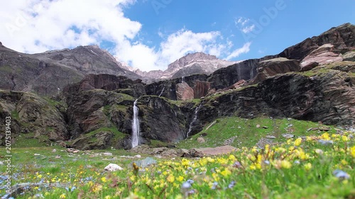 Mountains, wildflowers and waterfalls to Piani di Fora, Central Alps, Italy landscape