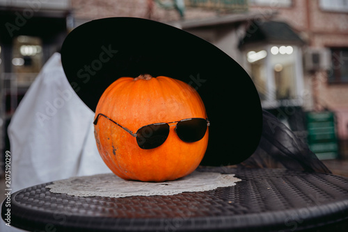 Vászonkép A creative and humorous conceptual shot of a bright orange pumpkin styled as a character