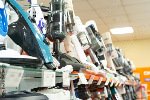 Variety of Modern Vacuum Cleaners Displayed on Retail Shelves, Showcasing Diverse Designs and Technologies for Efficient Home Cleaning