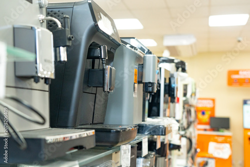 A Versatile Display of Modern Espresso Machines Showcasing Various Designs and Features in a Home Appliance Retail Environment