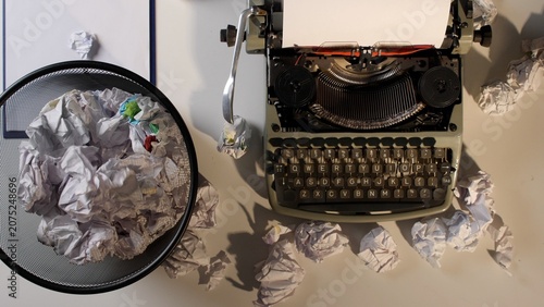 Canvas Print Vintage mechanical typewriter sitting on a desk with crumpled paper waste fillin