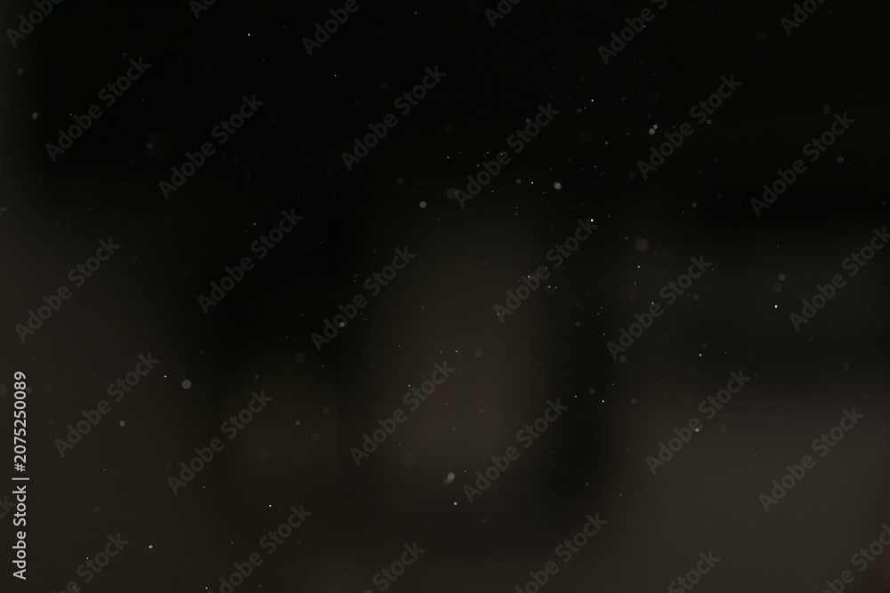 Fototapeta premium real dust particles floating in room with harsh light from light fixture