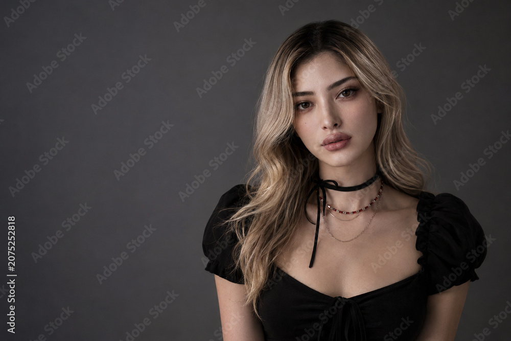 Fototapeta premium Elegant Young Woman Portrait with Dark Copy Space, Studio Fashion Beauty Concept