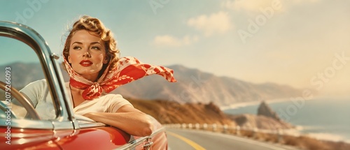 Beautiful young woman in vintage retro 1950s style with red headscarf driving classic convertible car on coast road