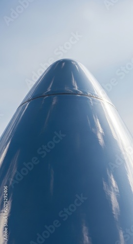 Close-up View of a Rocket Nose Cone Against a Blue Sky.