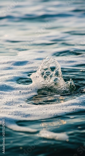 Close-up of Water Surface with Bubbles and Ripples in Natural Light.