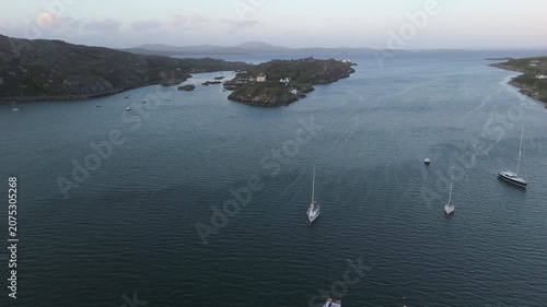 Aerial view of a bay, showcasing a fleet of small boats.