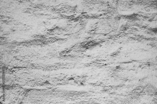 Darkened, dust-covered white plaster on the brick wall of a medieval fortress