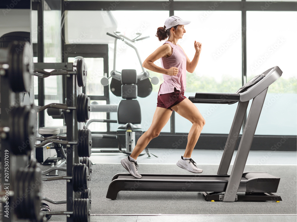 Fototapeta premium Woman running on a treadmill
