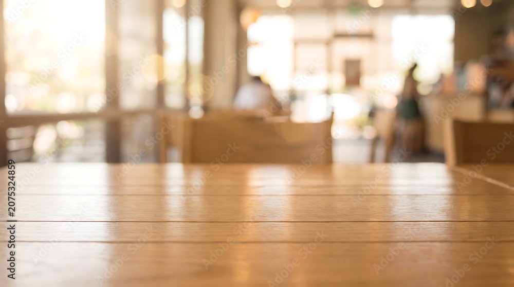 Fototapeta premium Empty wooden table in a cafe or restaurant with blurred background