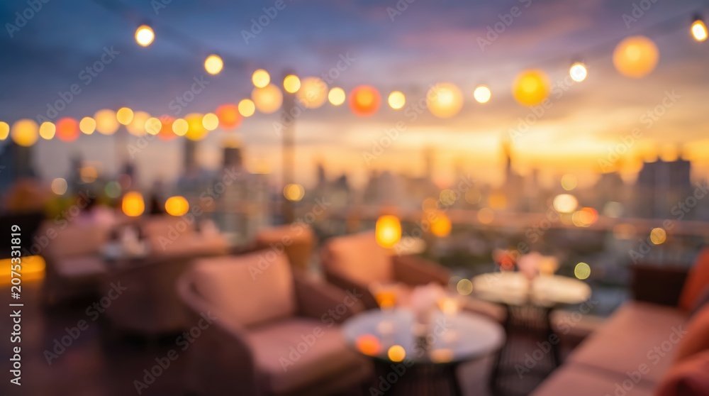 Fototapeta premium dreamy blurred rooftop lounge at sunset with warm string lights over a city skyline bokeh, cozy outdoor seating area, evening hospitality atmosphere.