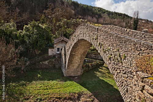Portico di Romagna, Forli Cesena, Emilia Romagna, Italy: ancient humpback bridge over the Montone River and the Oratorio della Visitazione, small historic church in the medieval village.
