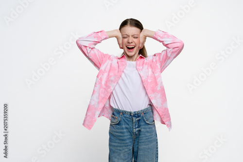 Картината върху платно Teenage girl covering her ears and screaming with eyes closed