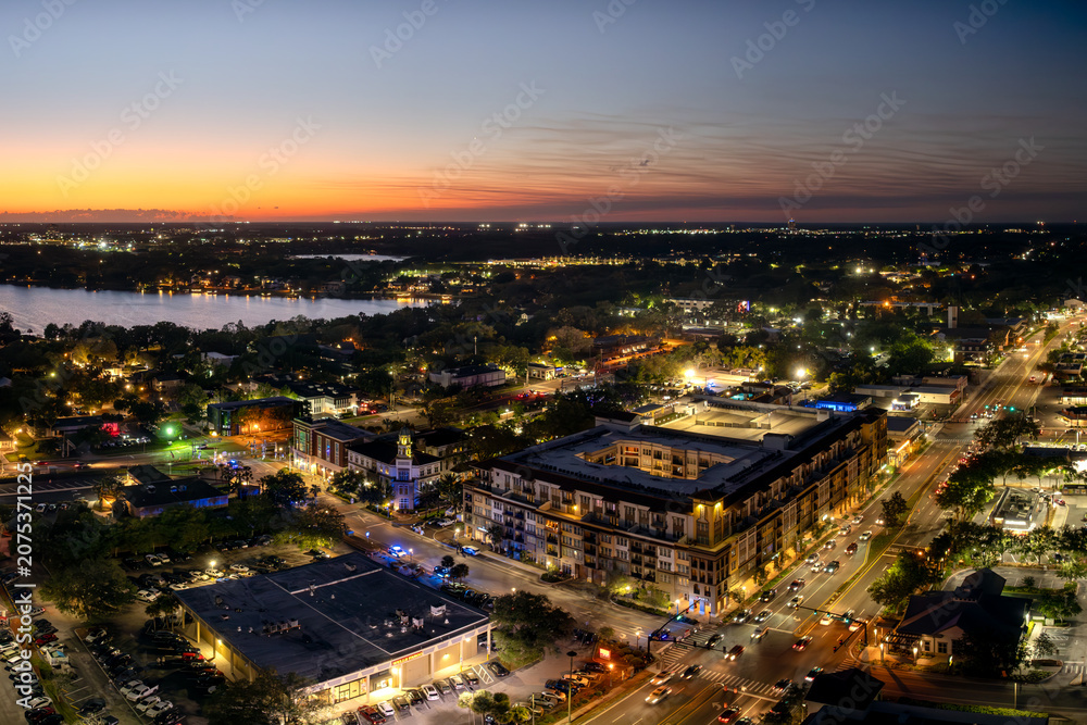 Fototapeta premium Aerial View of City Skyline and Illuminated Buildings in Maitland, Florida at Sunset. April 5, 2024. 