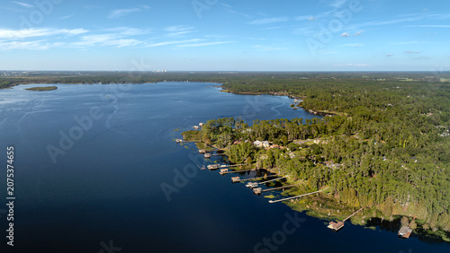 Fotografie Aerial Drone View of Lake Mary Jane in the Lake Nona, Orlando area featuring waterfront homes, private docks, and lush green forest, USA