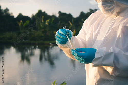 Close-up of a water quality inspector collecting samples for laboratory research and pollution monitoring.