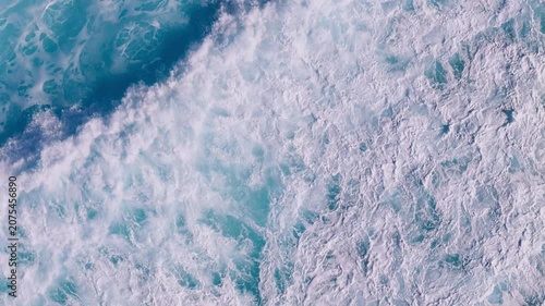 Top view of foamy ocean surface with powerful waves rolling across the Atlantic Ocean