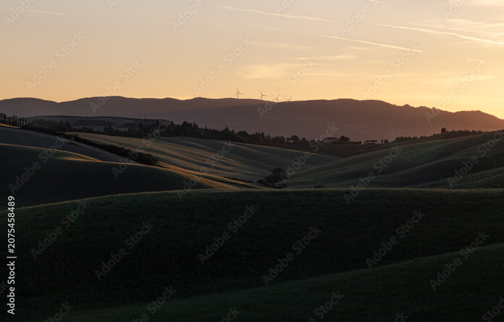 Obraz premium Tuscan Hills at Sunset with Wind Turbines and Cypress Trees, Italy