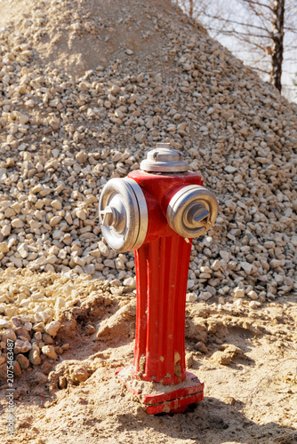 Canvastavla Bright red fire hydrant standpipe at a sandy construction site