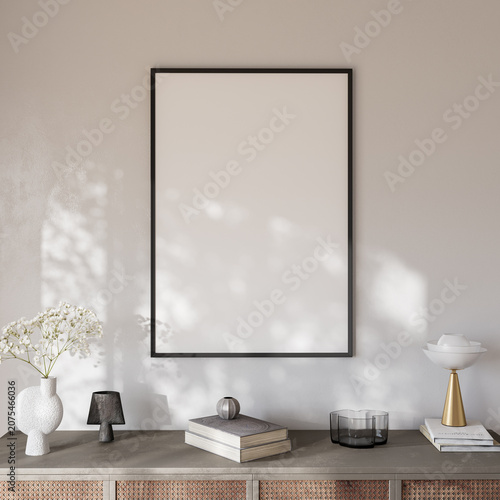 Blank poster frame mockup on beige wall above rattan sideboard with soft sunlight, 3d render