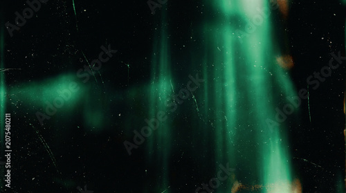 Abstract cinematic green light leaks and grunge film texture background with scratches