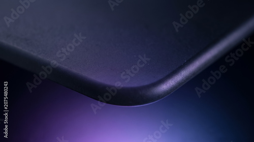 Minimalist dark frosted surface with subtle purple and blue gradient edge light