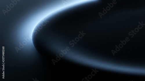 Macro photography of sleek dark minimalist surface with cold blue rim light abstract backdrop