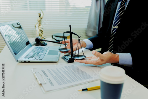 Photos Precise paralegal auditing lawsuit parameters on laptop to prepare flawless courtroom defense strategy