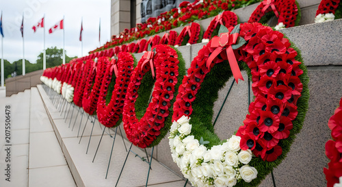 Red and White Floral Heart-Shaped Wreath on Stone Memorial with White Flowers Close Up