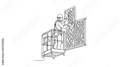 Construction worker in aerial platform installing decorative metal panel