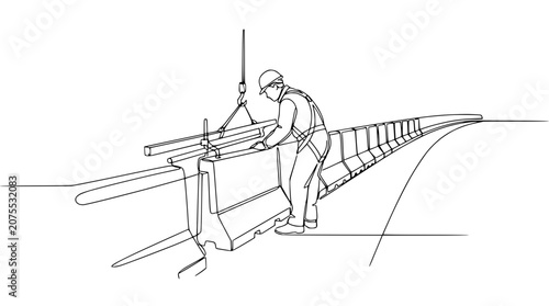Construction Worker Installing Concrete Barrier with Crane on Road