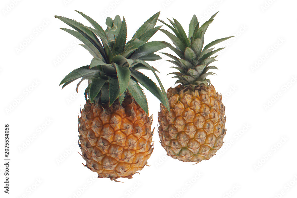 Fototapeta premium Ripe pineapples with woven basket and wooden stand isolated